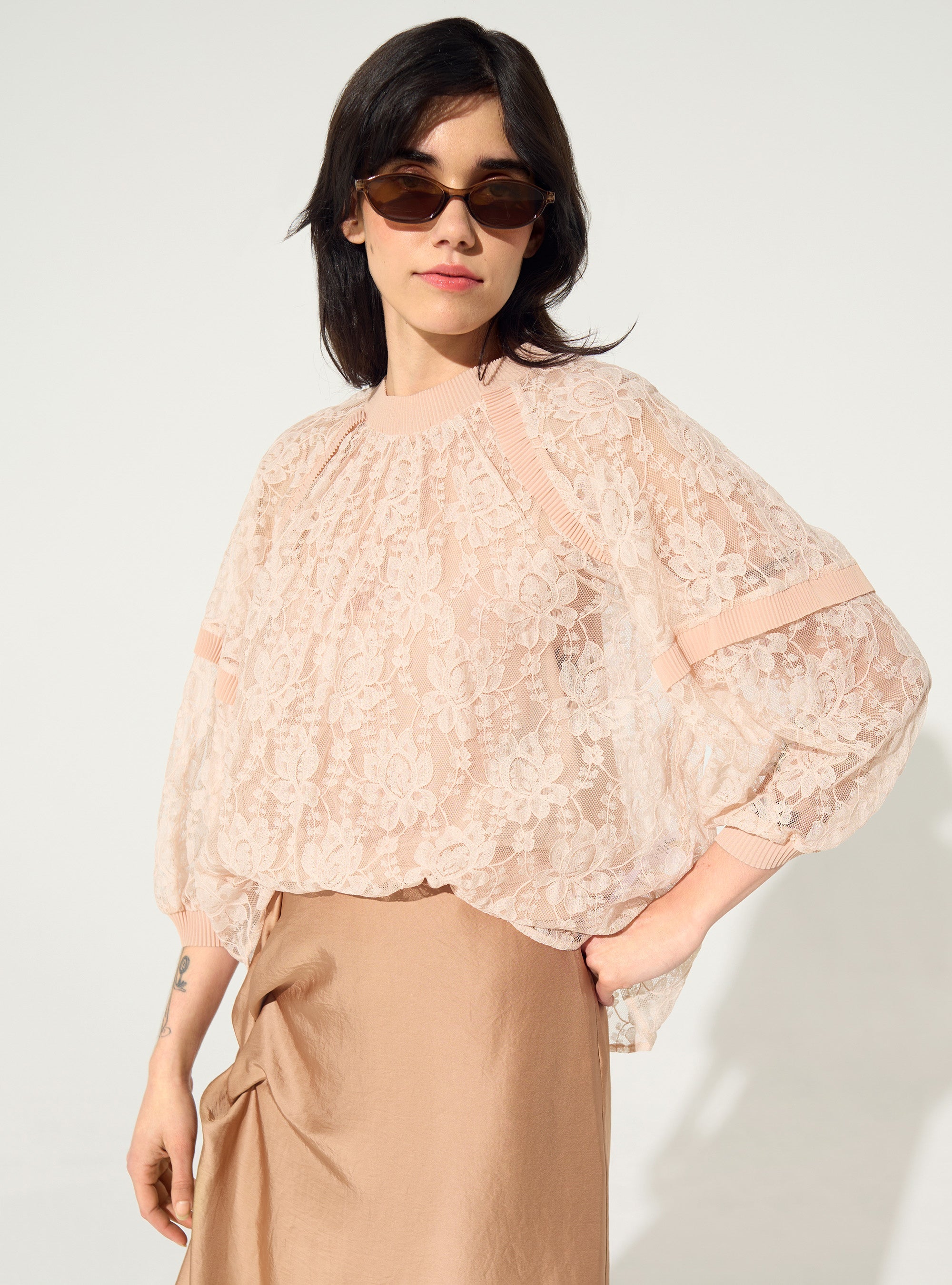 loose-fitting pleated pink lace blouse