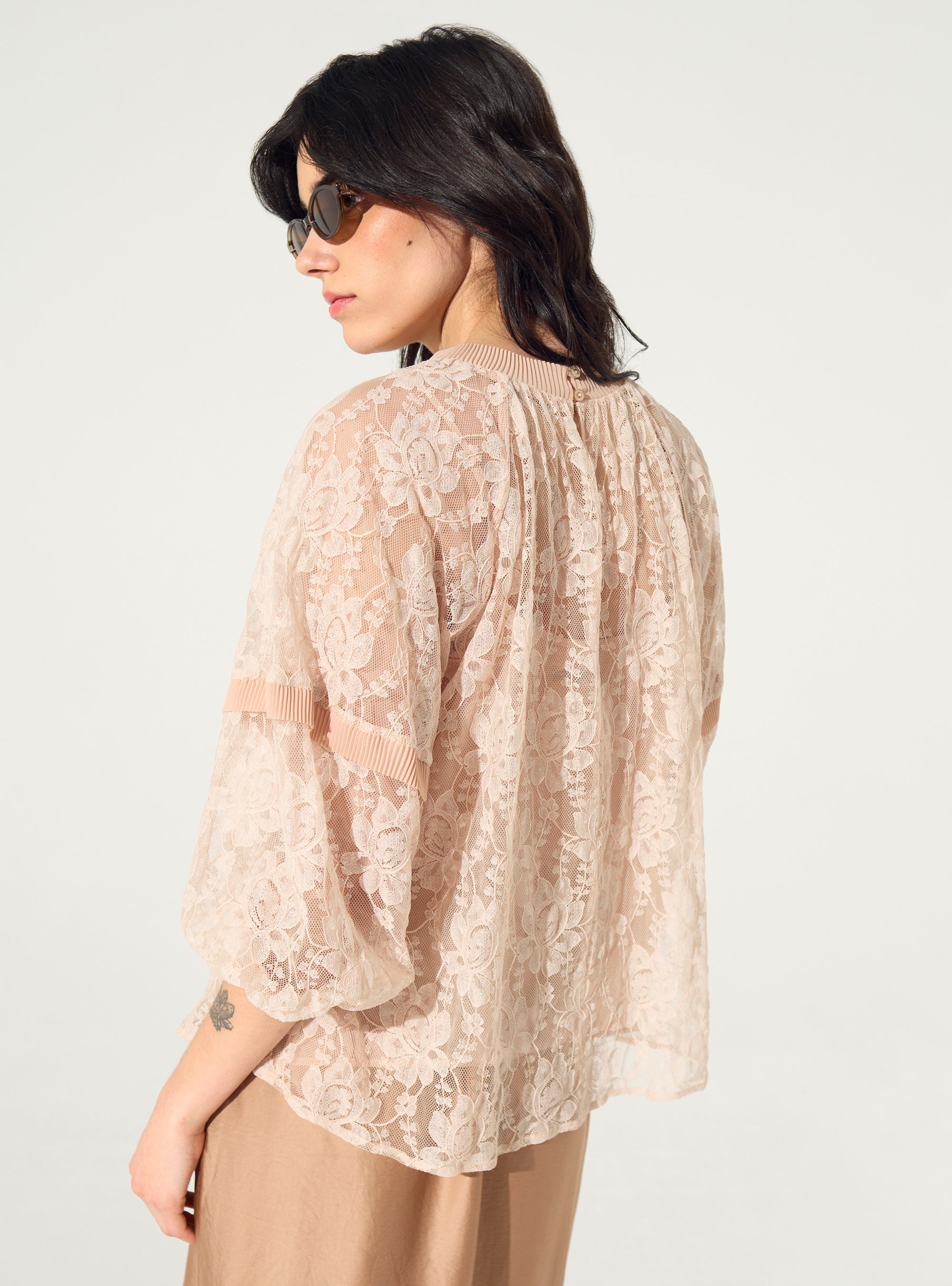 loose-fitting pleated pink lace blouse